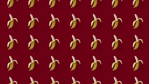Colorful fruit pattern of fresh yellow bananas on red background. Seamless Stock Footage 167486665