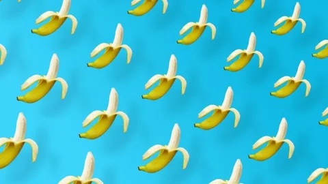 Colorful fruit pattern of fresh yellow bananas on blue background with shadows Stock Footage 167487057