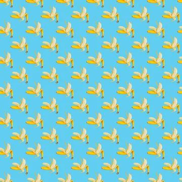 Colorful fruit pattern of fresh yellow bananas on blue background. Top view Stock Photos