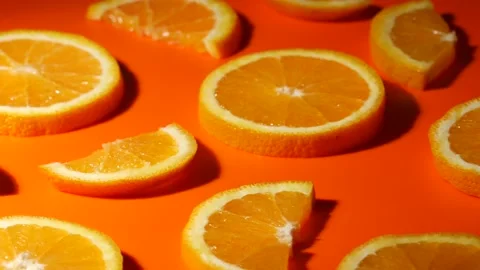 Colorful fruit pattern of orange slices on orange background. Top view. Stock Footage 133015577