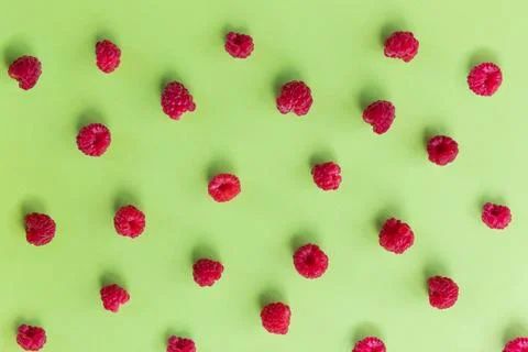 Colorful fruit pattern of wild berries on green background. Raspberries, Top Stock Photos