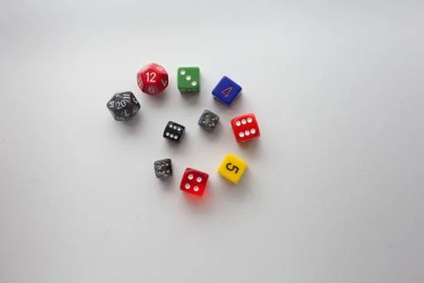 Colorful game dice swirled on a solid background Stock Photos