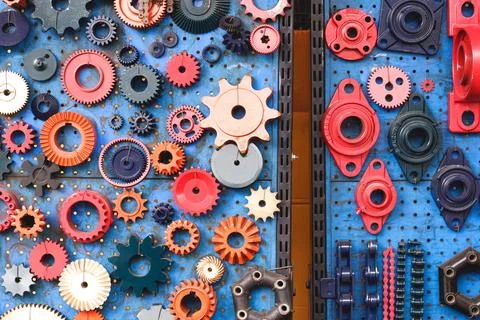 Colorful gears different size sample set on blue acrylic display board  Stock Photos