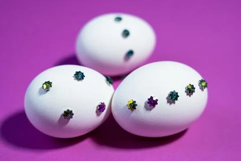 Colorful Gems on White Easter Eggs Over Pink Backdrop Stock Photos