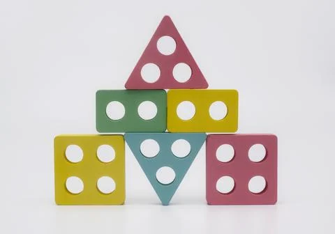 Colorful geometric block stack stands on white background. Multi colored wo.. Stock Photos