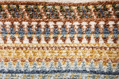 Colorful geometric pattern creating a textured background on a woven textil.. Foto stock