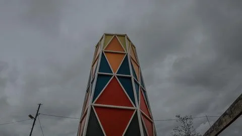 Colorful Geometric Tower Triangular Patterns with cloudy sky Stock Photos