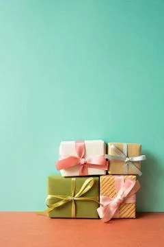 Colorful gift box on red table. mint green wall background Stock Photos