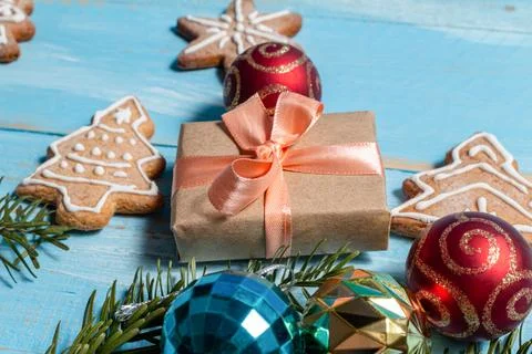 Colorful gift boxes fir, spruce toy cookies on a blue wooden background close Foto stock