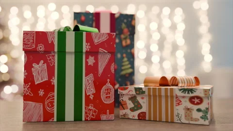 Colorful Gift Boxes Stacked on Table With Festive Decorations and Soft Bokeh Stock Footage 314781039