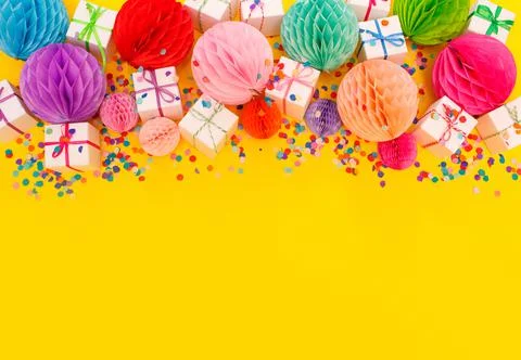 Colorful gift boxes on a yellow background top view. Stock Photos