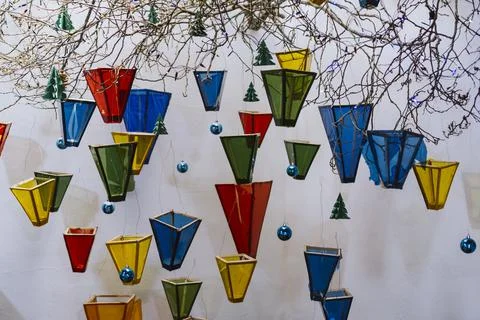 Colorful glass objects hanging from the tree branch with christmas ornaments Stock Photos