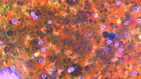 Colorful Glitters in Liquid Stock Footage 125552438