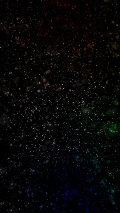 Colorful glowing blurred dots loop random flying on black vertical backgroun Video stock 346787294