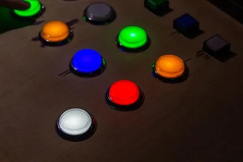 Colorful glowing buttons on a control panel for gaming or industrial equipmen Stock Photos