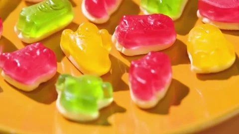 Colorful gummy candy ghosts top view on yellow background Stock Footage 345970429
