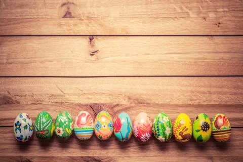 Colorful hand painted Easter eggs on wood. Unique handmade, vintage design. 스톡 사진