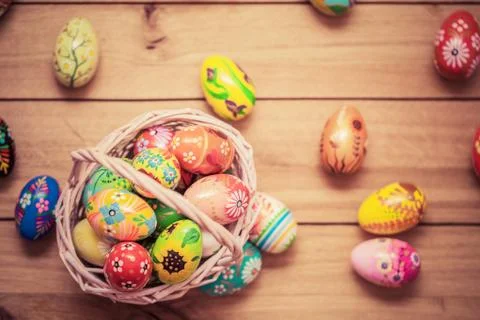 Colorful hand painted Easter eggs in basket and on wood. Traditional decorati Stock Photos