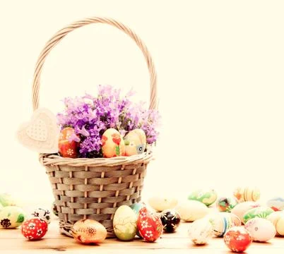 Colorful hand painted Easter eggs in basket and on wood. Traditional decorati Stock Photos