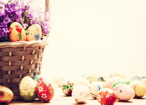Colorful hand painted Easter eggs in basket and on wood. Traditional decorati Stock-Fotos