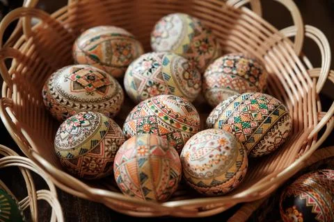 Colorful hand painted Easter Eggs in a wicker bowl. Egg decorating in Slavic Stock Photos