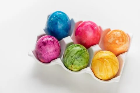 Colorful hand painted Easter eggs in ceramic holder, white background Stock Photos