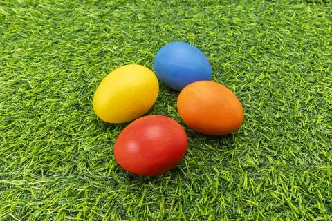 Colorful Hand Painted Easter Eggs on Green Artificial Grass Stock Photos