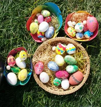 Colorful Hand Painted Easter Eggs in Baskets on Green Grass Stock Photos