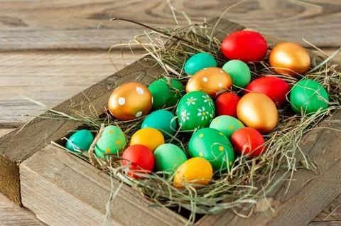 Colorful hand painted easter eggs in white wooden box on wooden table with .. Stock Photos