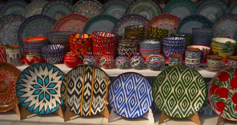 Colorful handmade ceramic tableware on market display with traditional patterns Stock Footage 333967096