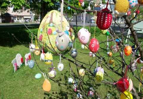 Colorful Handmade Easter Handmade Eggs Hanging on Tree Branches in City Park Stock Photos