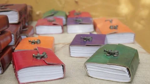 Colorful Handmade Leather Notebooks on Display at Craft Market Stock Footage 345279039
