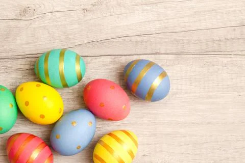 Colorful handmade painted easter eggs on a wood background. Stock Photos