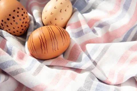 Colorful handmade painted Easter eggs on a textile background. Minimal concep Stock Photos