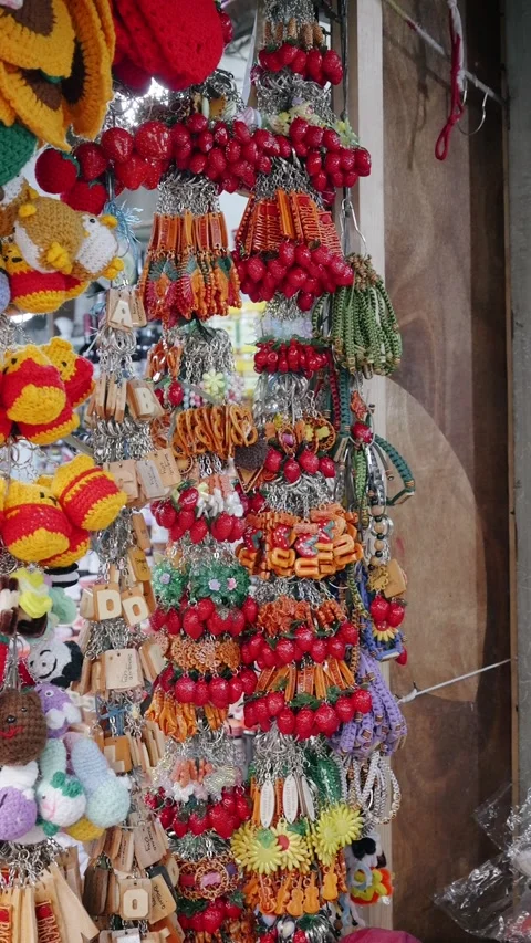 Colorful Handmade Strawberry Keychains And Crochet Toys Hanging At Market Stall Video stock 344330146
