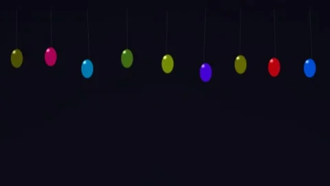 Colorful hanging balls in a dark background create a fun Stock Footage 338165365