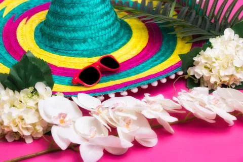 A colorful hat, some flowers and sunglasses Stock Photos