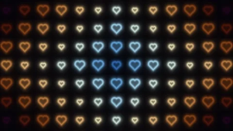 Colorful heart patterns glowing in a dark background Stock Footage 338225270
