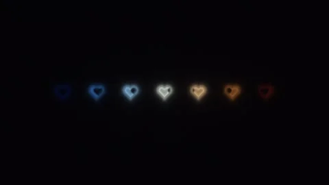 Colorful heart shapes creating a pattern on a dark Stock Footage 338388606