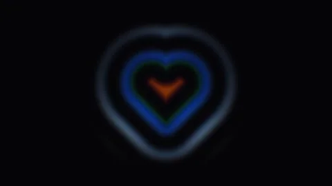 Colorful heart shapes form a pattern against a dark Stock Footage 338227432