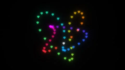 Colorful heart shapes form a pattern in dark space during Stock Footage 338288192
