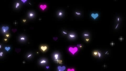Colorful hearts and sparkles float in slow motion on black Stock Footage 337523784
