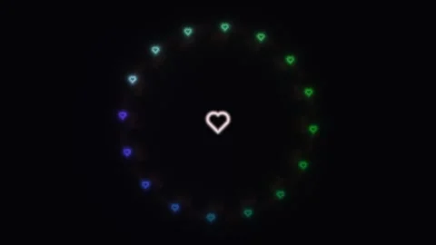 Colorful hearts float in a circular pattern on a dark Stock Footage 338293422