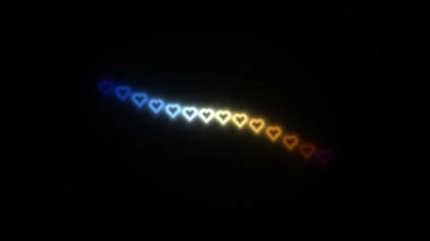 Colorful hearts float in a wave pattern across a dark Stock Footage 338317534