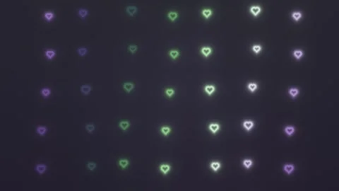 Colorful hearts light up the dark background in a pattern Stock Footage 339329639