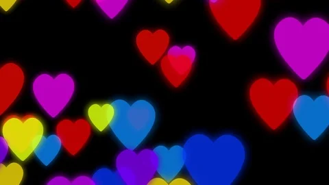 Colorful hearts slowly falling down on a dark background with particles Stock Footage 70987101