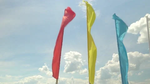 Colorful holiday flags flutter in the wind against the blue sky, Stock Footage 155815239