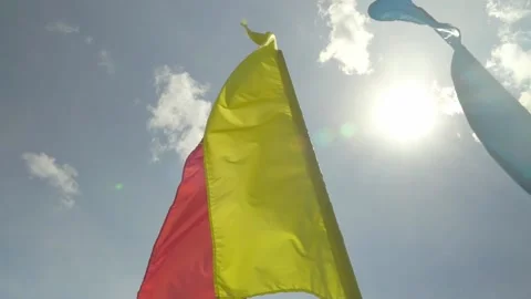 Colorful holiday flags flutter in the wind against the blue sky, Stock Footage 155816684