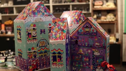 Colorful holiday gift boxes designed as festive houses with playful illustration Stock Footage 317506956