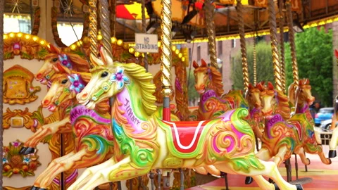 The colorful horses of the carousel move in a circle with speed. Stock Footage 274734272